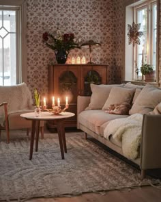 a living room filled with furniture and candles