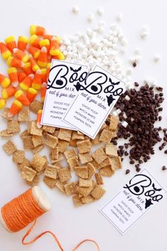 corn chips, candy corn and dog treats are laid out on a white surface with twine spools