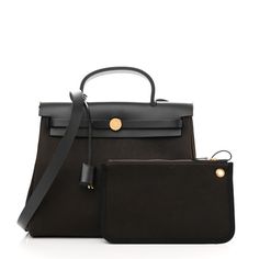 SCUThis is an authentic HERMES Toile Vache Hunter Herbag Zip Retourne 31 PM in Black and Ebene. This stylish tote is crafted of sturdy toile canvas in dark brown.The shoulder bag features a rear exterior zip pocket, a brown leathertop crest with a leather top handle, a shoulder strap, and strap closure with polished gold hardware including a padlock. The flap opens to a canvas interior with a removable pouch. Designer Brown Canvas Bag With Top Handle, Luxury Brown Canvas Bag With Detachable Handle, Luxury Brown Canvas Bag With Removable Pouch, Brown Canvas Bag With Detachable Handle, Luxury Brown Top Handle Canvas Bag, Brown Canvas Satchel With Dust Bag, Brown Top Handle Coated Canvas Bag, Black Leather Canvas Bag With Dust Bag, Brown Coated Canvas Bag With Top Handle