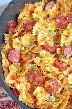 a skillet filled with pasta and pepperoni