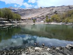 a body of water surrounded by mountains and trees