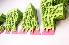 three pieces of paper cut into the shape of trees