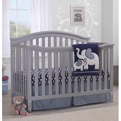 the baby crib has an elephant pillow on it