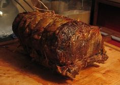 a large piece of meat sitting on top of a wooden cutting board