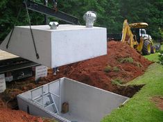 a large white box sitting on top of a dirt field