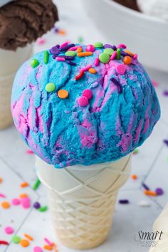 two ice cream cones with sprinkles on them