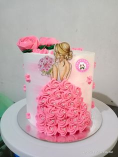 a cake decorated with pink flowers and a woman's face on the top layer