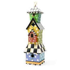 a multicolored birdhouse with polka dots on it