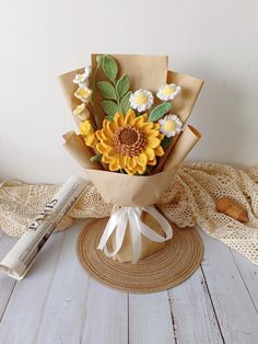 a bouquet of sunflowers is wrapped in brown paper