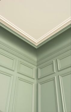 an empty room with green cabinets and a white ceiling