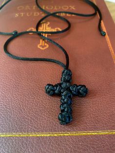 A resizable cord cross made with the same knots as traditional Orthodox prayer ropes. The soft, adjustable design makes it perfect for children and the aesthetically pleasing design of the knots is perfect for adults! Handmade Adjustable Cross Pendant Necklace, Handmade Adjustable Black Cross Necklace, Adjustable Spiritual Cross Necklace, Adjustable Spiritual Cross Pendant Necklace, Handmade Adjustable Cross Necklace, Orthodox Prayers, Favorite Jewelry, Jewelry Necklace Pendant, Beauty Book