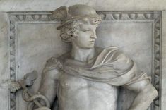 a statue of a man with a snake around his neck and hands in his pockets