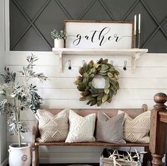 a living room with a couch, coffee table and wreath on the wall