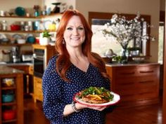 a woman holding a plate with food on it