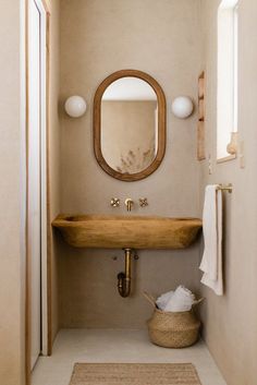 a bathroom with a sink, mirror and rug on the floor in front of it