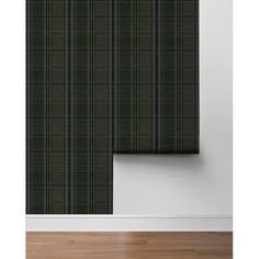 a black and green plaid wallpaper with vertical blinds in an empty room next to a wooden floor