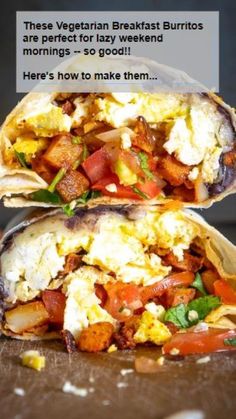 two burritos with eggs, tomatoes and other toppings are on a table