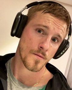 a man wearing headphones and looking at the camera