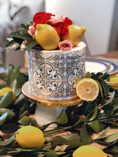 a decorated cake with lemons and roses on top