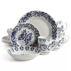 a blue and white dinner set on a white background