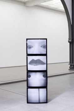 a black and white photo of a woman's face on display in an art gallery