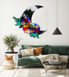 a living room with a green couch and large stained glass crescent decoration on the wall