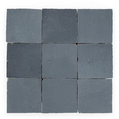 several squares of gray slate tile on a white background