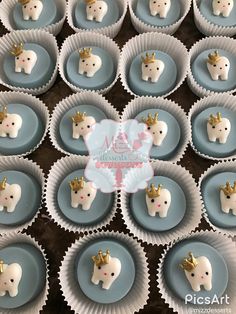 cupcakes decorated with toothpicks and crowns on blue plates