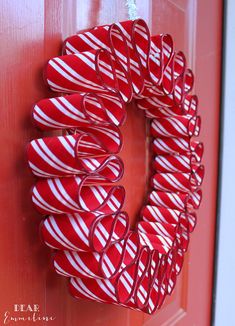 a candy cane wreath hanging on the front door