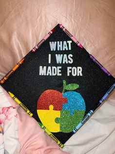 a black graduation cap with the words what i was made for and an apple on it