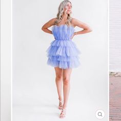 If Carrie Bradshaw Was A Dress! This Strapless Tulle Mini Dress In Dusty Blue Features A Tiered Tulle Fabrication. Designed With A Structured Waistband. Finished With A Strapless Neckline And An Inner Clear Bust Stopping. Blue Tulle Mini Dress For Wedding, Strapless Tulle Mini Dress For Spring, Elegant Blue Tulle Mini Dress, Summer Bridesmaid Strapless Tulle Dress, Blue Mini Tulle Dresses, Summer Party Strapless Tulle Dress, Summer Strapless Tulle Dress With Tulle Skirt, Blue Tulle Dress For Summer, Spring Strapless Mini Tulle Dress