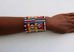 African beaded bracelets, Maasai Cuff Bracelets, Maasai Wrist bracelets, Beaded bangles, Beaded Cuff bracelets, Christmas gift, Moms gift The bracelet is made by the Maasai women in Kenya.  It is beautiful and can compliment any outfit. Available in medium and large size Medium size: fits a standard wrist size of 7.5 inches Large Size: fits a wrist size of 8.5 inches Shipping fee is for the first item only. Other items ship for FREE! Shipping via DHL Express that takes 3-5 days to be delivered. To view more items from our shop, kindly click here: nkoroicrafts.etsy.com Thank you for visiting! Multicolor Cuff Bracelet For Festivals And Gifts, Multicolor Cuff Bracelet As Gift For Festivals, Multicolor Hand Wrapped Bangle For Gift, Multicolor Hand Wrapped Bangle As Gift, Traditional Multicolor Cuff Bracelet As Gift, Traditional Beaded Bangle As Gift, Traditional Multicolor Rectangular Beaded Bracelets, Traditional Beaded Wristband Gift, Festive Beaded Bangle For Gift