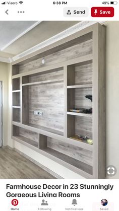 an empty living room with wooden shelves on the wall and wood flooring in front of it