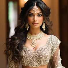 a woman in a bridal outfit with jewelry on her neck and shoulder, posing for the camera