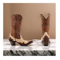 Idyllwind Women's Speedway (Snip Toe) Western Boots Medium Sizes, featuring a classic brown color scheme and a chic tan vamp with a brown shaft and intricate overlay design that adds a touch of sophistication to your outfit. Made from high-quality leather, these boots offer a timeless and stylish look that's perfect for any occasion. The snip toe and pull-on style with pull tabs make these boots easy to slip on and off, while the 12" shaft height provides coverage and support. The Western heel a Country Style Brown Boots With Reinforced Heel, Brown Pointed Toe Country Boots, Casual Brown Boots For Ranch, Brown Pointed Toe Boots For Rodeo, Fitted Beige Boots For Ranch, Retro Brown Pointed Toe Boots, Brown Almond Toe Boots For Rodeo, Brown Boots With Reinforced Heel For Western-themed Events, Brown Closed Toe Boots For Ranch