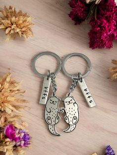 Celebrate your unbreakable bond with these Best Friend Otter Keychains. These best friend matching keychains feature laser engraved stainless steel otter charms accompanied by hand-stamped BFFS charms, perfect to symbolize your lifelong friendship. The cute little otter paws link together and just as otters mate for life, these matching keychains will remind you and your best friend of your enduring connection.  Details: You will receive 2 keychains as shown in photos Keychain measures approx. 9cm (3.5") in total length Otter charms are laser engraved stainless steel bffs charms are made from aluminum and are hand stamped Original poem is printed on a tag-shaped cardstock and keychains are individually packaged as shown The included "Otter, Best Friend" poem was written by It's All About Y Otter Paws, Otter Keychain, Best Friend Keychain, Best Friend Matching, Friend Keychain, Otter Gifts, Matching Keychain, Friend Poems, Best Friend Match