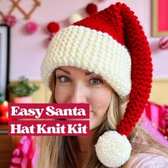 a woman wearing a red and white knitted santa hat