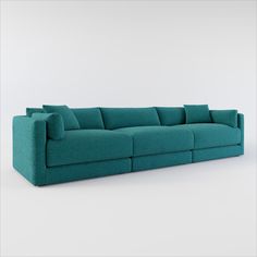 a blue couch sitting on top of a white floor