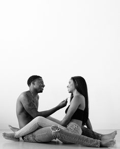 a man and woman sitting on the floor talking