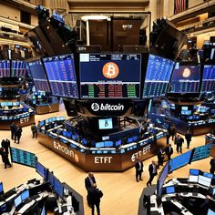 people are standing in front of the bitcoin trading floor