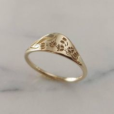 Elegant and unique 14k gold birth flower signet ring, A new stackable version of our beloved vintage style floral wedding band. * Band width: 1.5 mm, wide part width: 5 mm* Thickness: 1.5 mm* Available in 14K or 18K YELLOW, WHITE and ROSE gold.   The price listed is for 14K please contact me for 18K pricing.* Sizes vary from 5 US to 9 US, including half sizes.    Please choose your size upon checkout.* Please choose a finish: Shiny or Matte, and mention in note to seller.* This item is handmade, Floral Wedding Band, Lily Jewelry, Floral Wedding Bands, 14k Gold Wedding Band, Fine Gold Jewelry, Birth Flower, Gold Wedding Rings