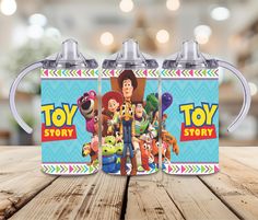 two toy story mugs sitting on top of a wooden table