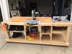 a workbench made out of pallet wood with tools on the table top