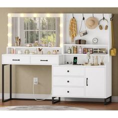 a white desk with drawers and lights on it next to a window in a room