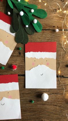 paper santas are on the table next to some christmas decorations