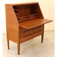 a wooden desk with an open drawer on top