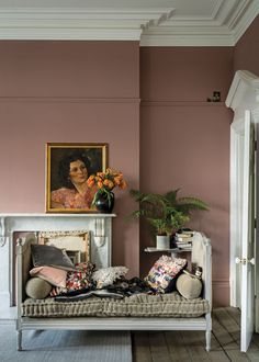 a living room filled with furniture and a painting on the wall