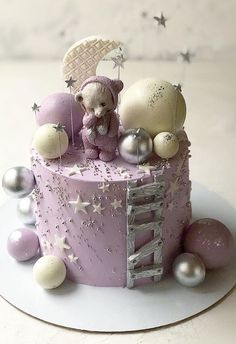 there is a cake that has been decorated with balls and teddy bears on it, as well as other decorations