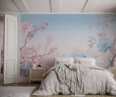 a bedroom with pink and blue flowers on the wall