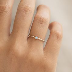 This dainty ring features a round opal centerstone with three brilliant lab grown diamonds delicately arranged on both sides. Crafted in 14k gold. 


1 round opal cabochon gemstone with a width of 3mm

6 round lab grown diamonds with a width of 1.2mm

6 lab grown diamonds have a total carat weight of 0.048

14k yellow gold band


 Size: 5, 6, 7, 8, 9 Opal And Diamond Ring, Dainty Rings, Opal Ring Gold, Big Rings, Detailed Ring, Peridot Ring, Shiny Things, Sustainable Jewelry, Traditional Jewelry